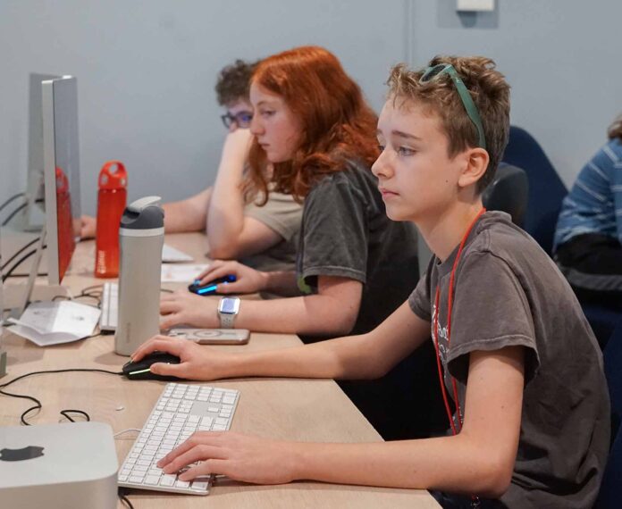 Students looking at computer screens in a computer lab classroom