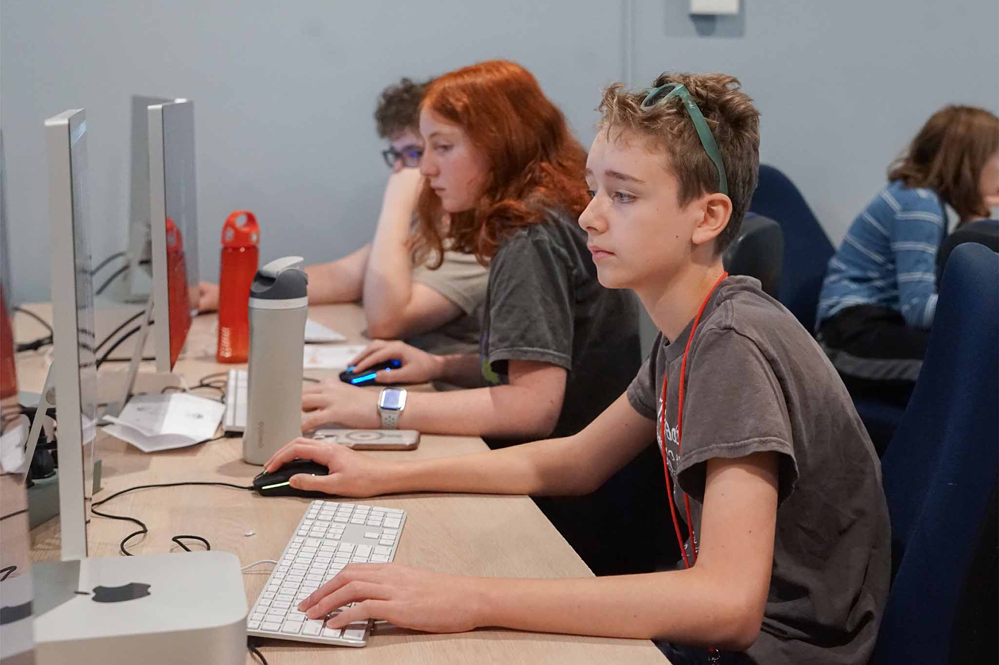 Students looking at computer screens in a computer lab classroom