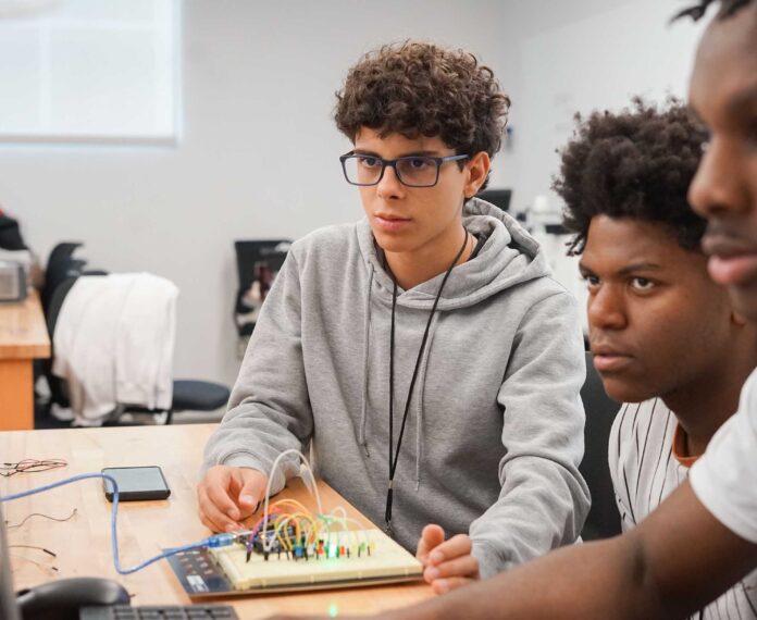 Three students working a on a engineering project.