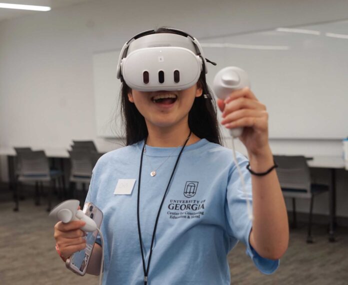 Female student using VR technology in a classroom.