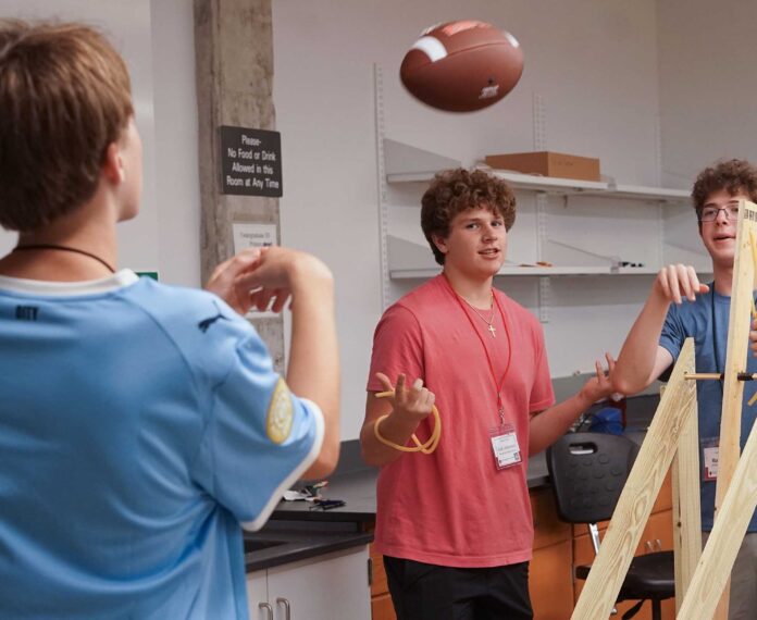 three students working on a engineering project