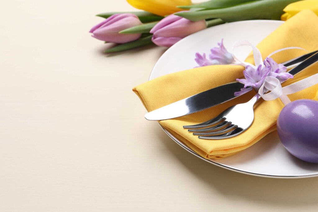 Festive Easter table setting with egg on beige background.