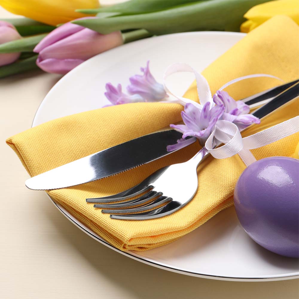 Festive Easter table setting with egg on beige background.