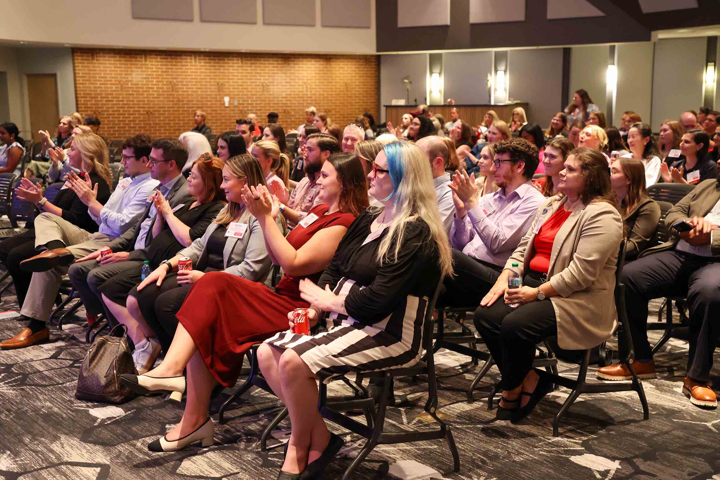 A group of people inside of Mahler Hall attending a conference