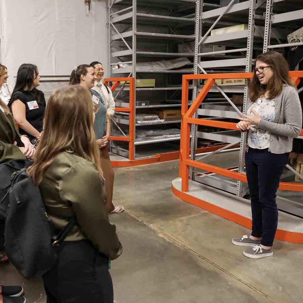 View inside of Special collections Library vault with a guide and group tour