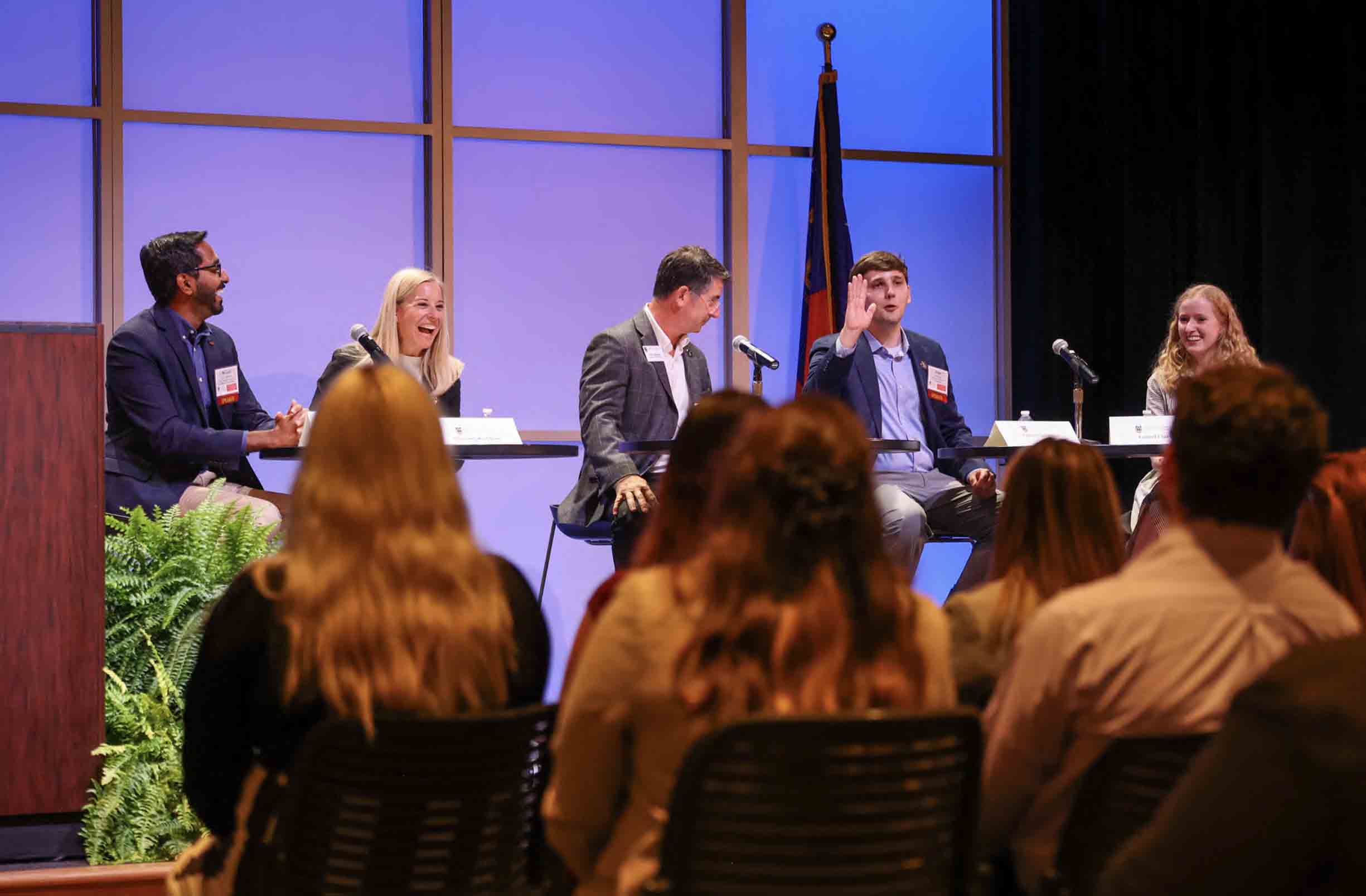Six Public Service & Outreach employees on a stage in Mahler Hall