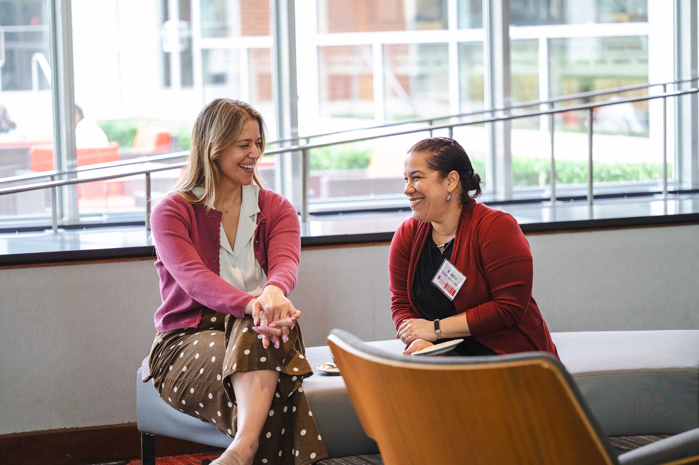 Two women sitting and talking in the Pecan Gallery in the Georgia Center